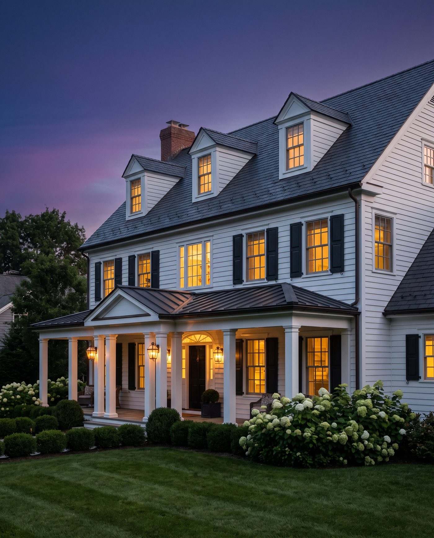 A premium home exterior by Roof Wranglers at twilight.